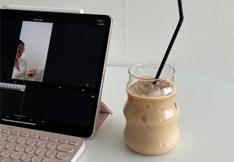 Aesthetic stock image showing an iPad open with an editing page visible and an iced latter. The image is purely for decorative us only to support the blog post on how to be productive after your 9-to-5