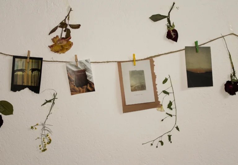 Aesthetic stock image showing a set of photographs hung up in a line along a white wall. The image is purely for decorative use only to support the blog pots on evening routine ideas.