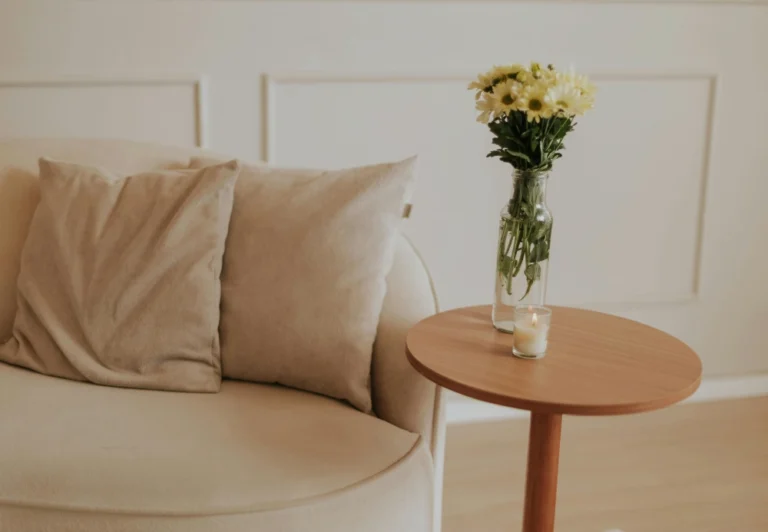 Aesthetic stock image showing a beige sofa in a living room next to a wooden coffee table. The image is purely for decorative use only to support the blog post on how to quit your job.