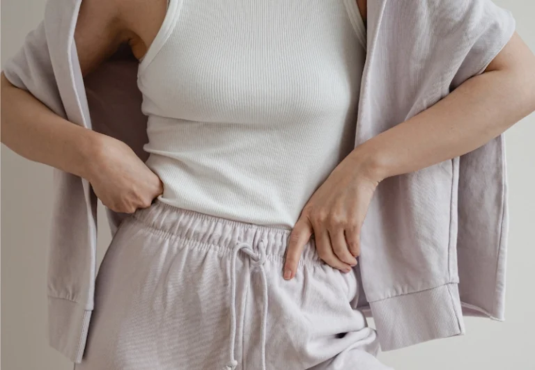 Aesthetic stock image showing a woman wearing lilac gym gear and posing with her hands on her hips. The image is purely for decorative us only to support the blog post on why self-improvement is making you even more burnt out.