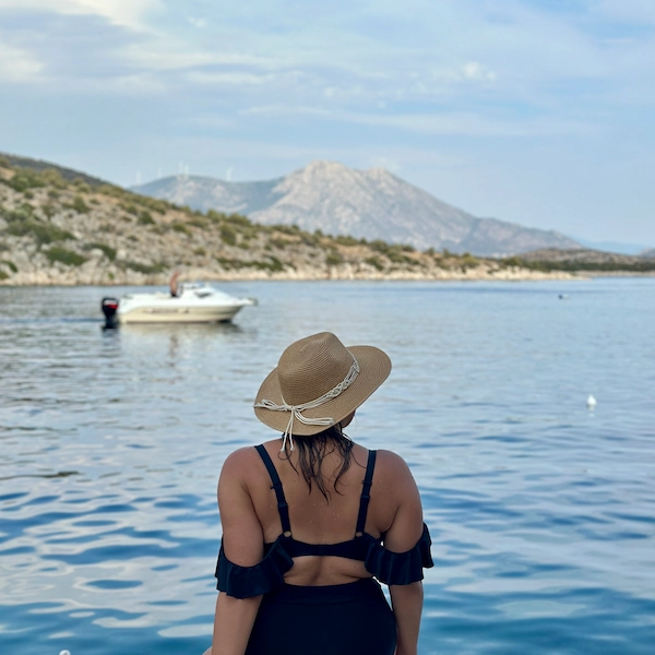 Recent picture of Thalia, author of Notes by Thalia taken in September 2024 sitting in front of the sea in Greece