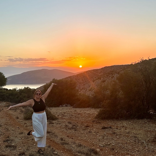 Recent picture of Thalia, author of Notes by Thalia taken in October 2024 posing in front of the sunset in Greece