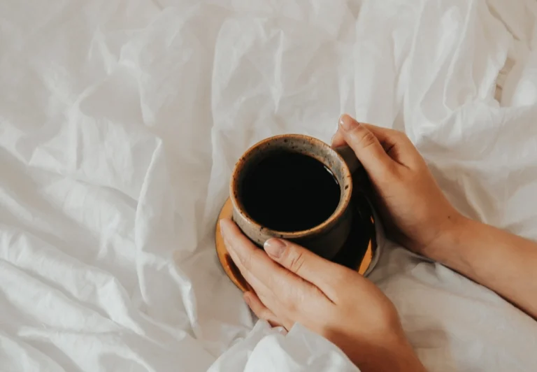 Aesthetic stock image showing a woman’s hands holding a mug of coffee. The image is purely for decorative us only to support the blog post on things to do on your daily commute.