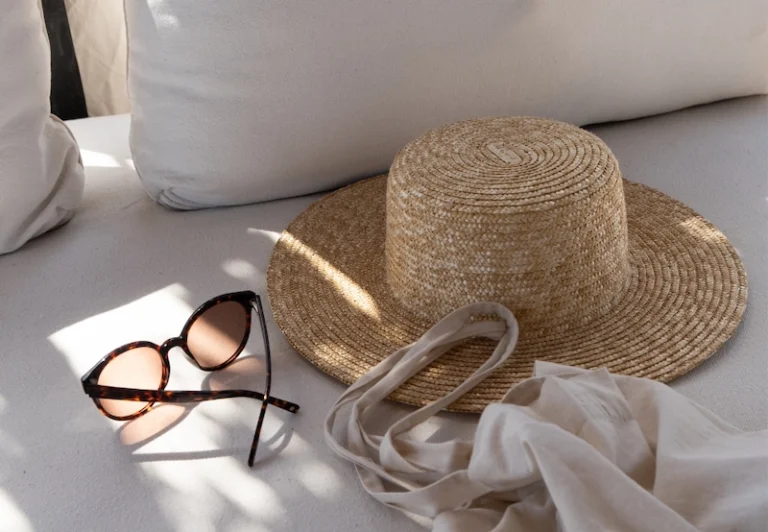 Aesthetic stock image showing a sun bed setup with a straw hat, sunglasses. The image is purely for decorative use only to support the blog post on the things to do after quitting you job